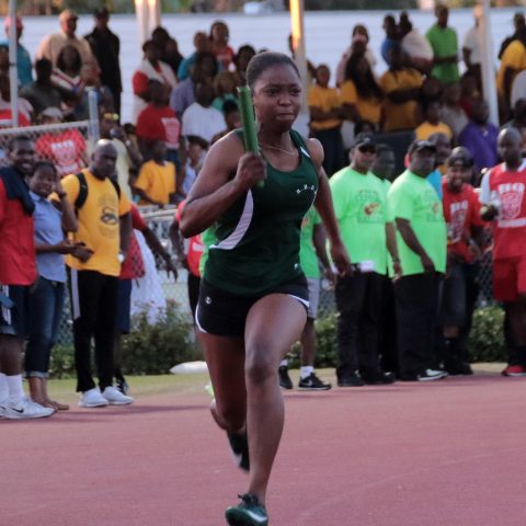 Woman Marine Nyesha Ferguson running the second leg of the 4 x 100 meter relay at the Police Track Meet on April 4, 2018 at the Thomas A. Robinson Stadium. The Royal Bahamas Defence Force females placed first in that event.