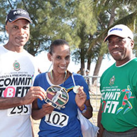 Eve Dorsette Maycock receiving her award as the top female walker at the RBDF Fun Run/Walk and Health expo on April 14, 2018 also shown are: RBDF Commodore Tellis Bethel and Training Officer Lieutenant Origin Deleveaux Jr.