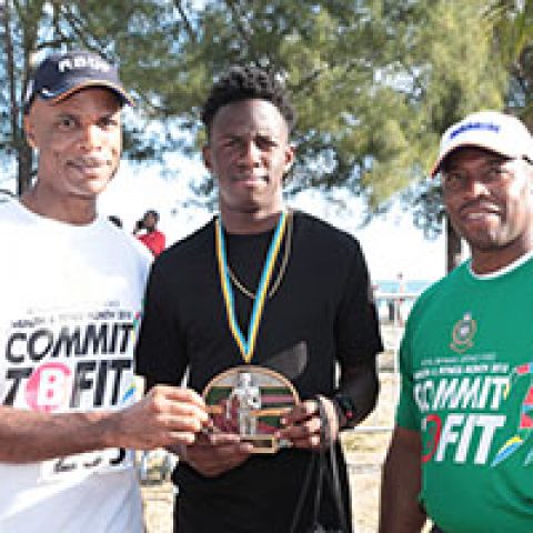 Glenroy Williams receiving his award as the top male runner at the RBDF Fun Run/Walk and Health expo on April 14, 2018 also shown are: RBDF Commodore Tellis Bethel and Training Officer Lieutenant Origin Deleveaux Jr.