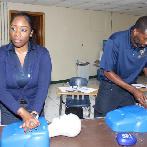Representatives from The Bahamas Customs Department participating in a simulation exercise during the American Heart Association First Aid and CPR Training at the Coral Harbour Base. From left: Grade 2 Customs Officers Robyn Stuart and Lloyd Bodie.
